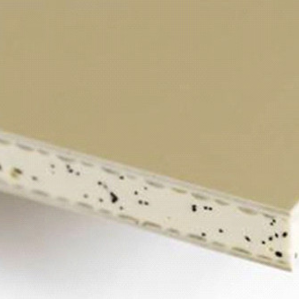 Närbild av en beige laminerad bänkkant. Ytan är slät, med den exponerade kanten avslöjar lager och fläckiga mönster. Bilden fokuserar på hörnet där toppen och sidan möts.